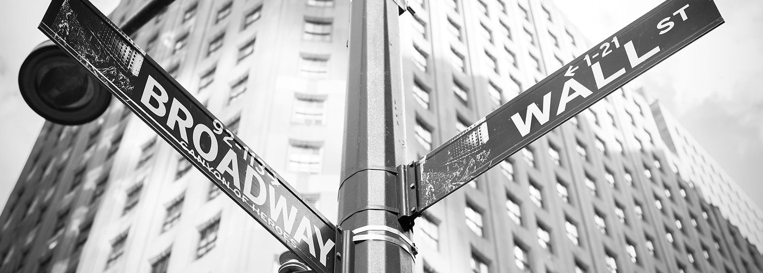 Street signs at intersection of Wall Street and Broadway